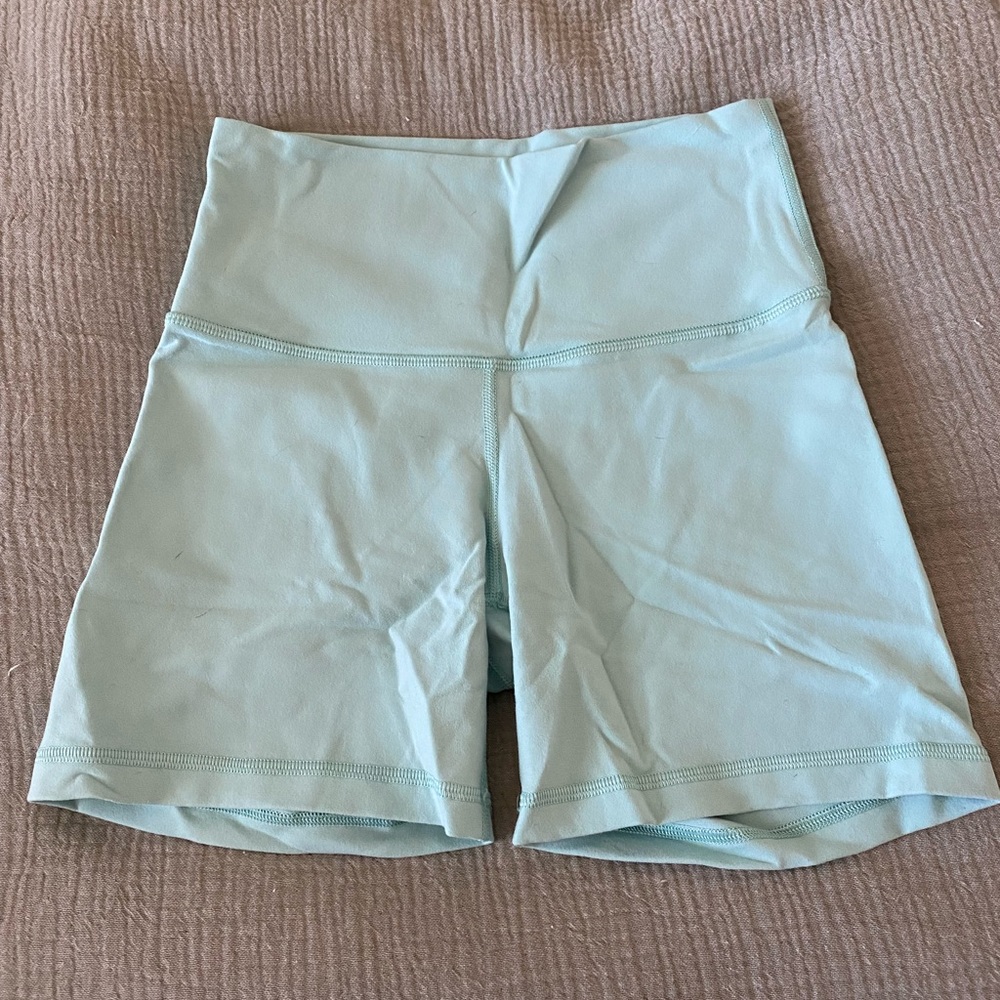 Aritzia TNA biker shorts in teal color - size small